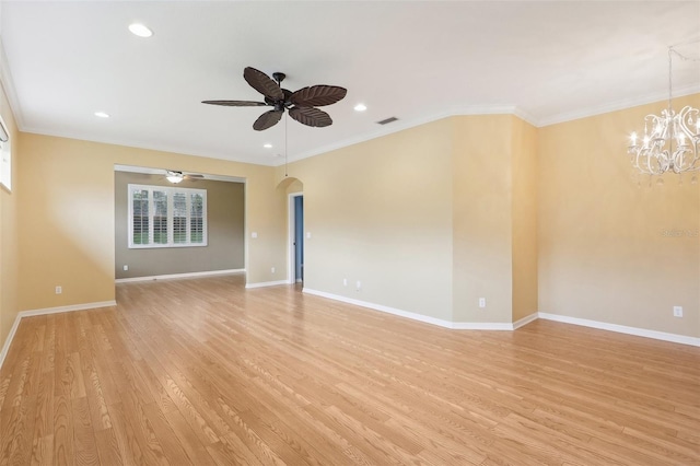 empty room with light wood-type flooring, ceiling fan with notable chandelier, and ornamental molding