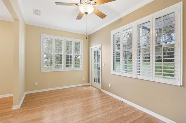 unfurnished room featuring light wood-type flooring, a wealth of natural light, crown molding, and ceiling fan