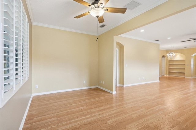 spare room with ceiling fan with notable chandelier, crown molding, and light hardwood / wood-style floors