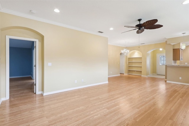 unfurnished living room featuring light wood-type flooring, ceiling fan with notable chandelier, and crown molding