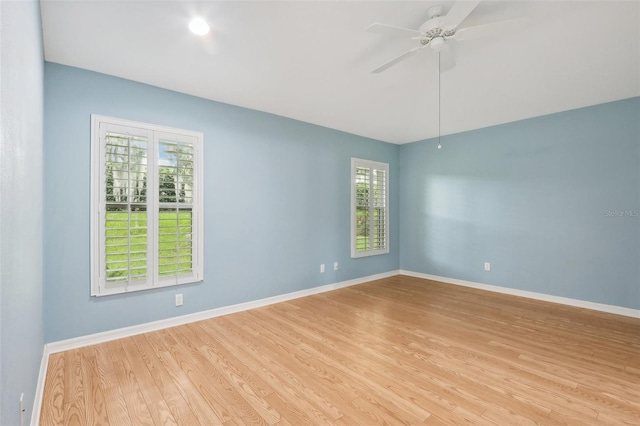 unfurnished room with light hardwood / wood-style flooring, ceiling fan, and a healthy amount of sunlight