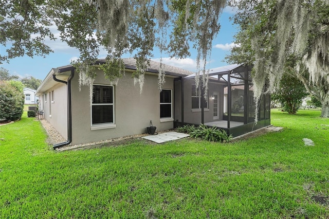 rear view of property with a yard