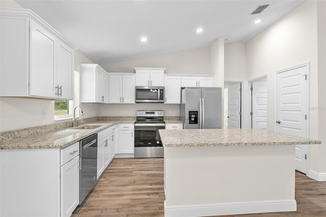 kitchen featuring white cabinetry, stainless steel appliances, and a kitchen island