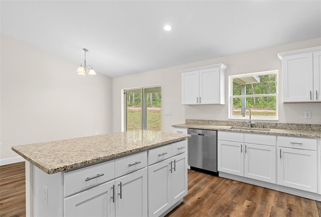 kitchen with dishwasher, a center island, pendant lighting, sink, and white cabinets