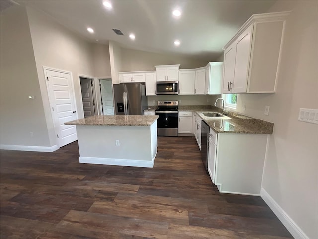 kitchen with sink, white cabinetry, appliances with stainless steel finishes, and a kitchen island