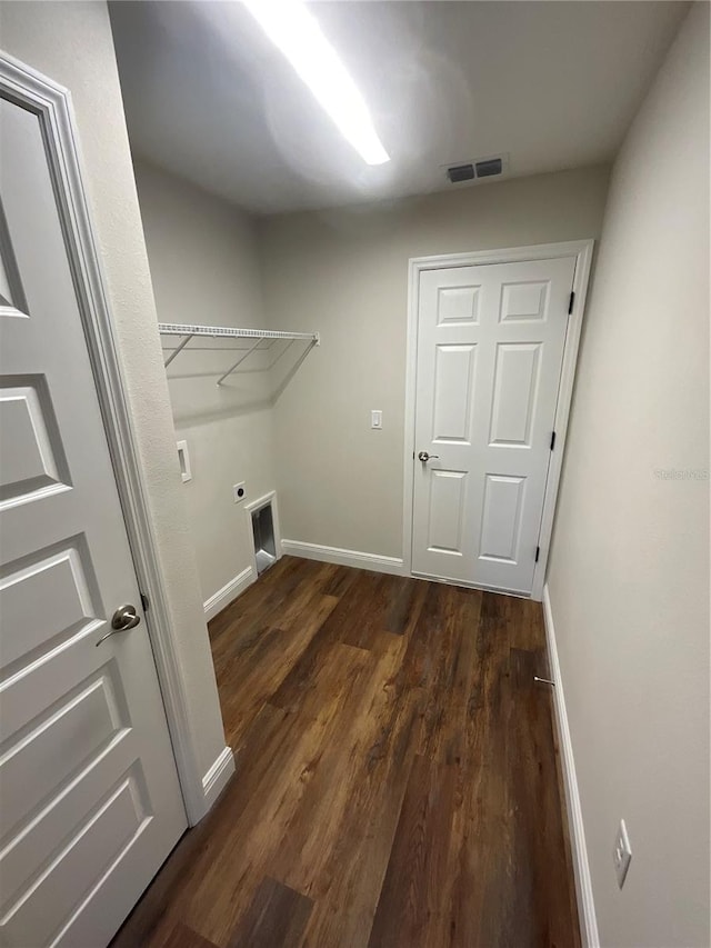 washroom with dark hardwood / wood-style flooring and electric dryer hookup