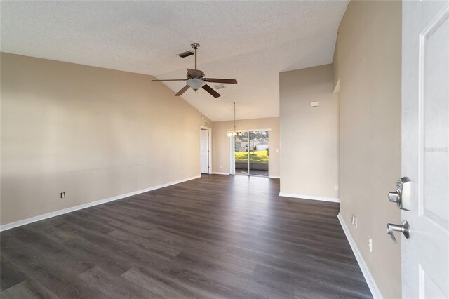 unfurnished room featuring dark wood-type flooring, lofted ceiling, ceiling fan with notable chandelier, and a textured ceiling