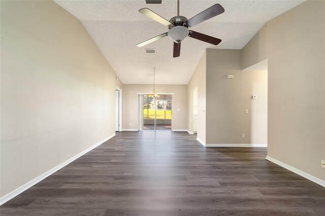 empty room with lofted ceiling, ceiling fan with notable chandelier, dark wood-type flooring, and a textured ceiling