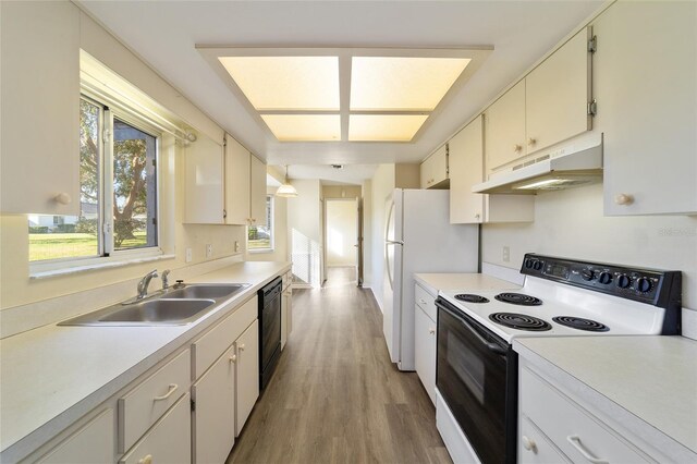 kitchen featuring sink, light wood-type flooring, dishwasher, electric stove, and white cabinets