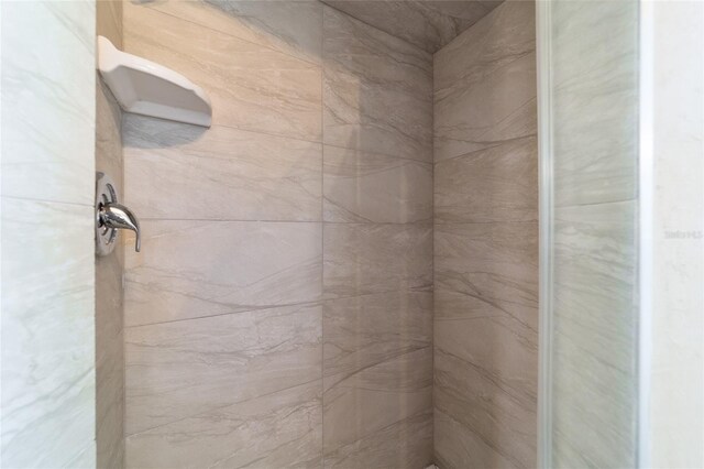 bathroom with a tile shower