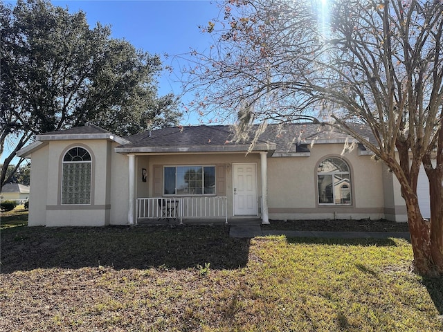 single story home featuring covered porch and a front lawn