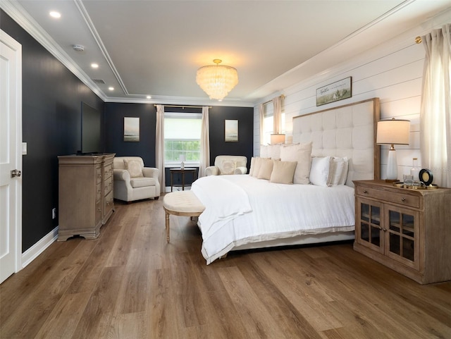 bedroom with ornamental molding and hardwood / wood-style flooring