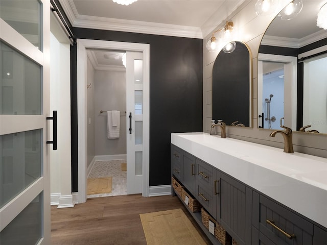 bathroom featuring vanity, wood-type flooring, and ornamental molding