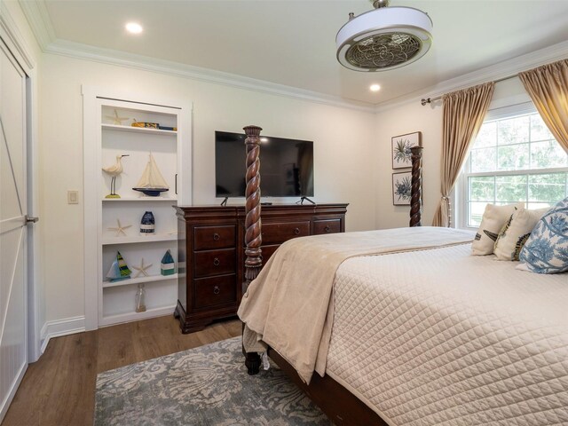 bedroom featuring ornamental molding and hardwood / wood-style flooring