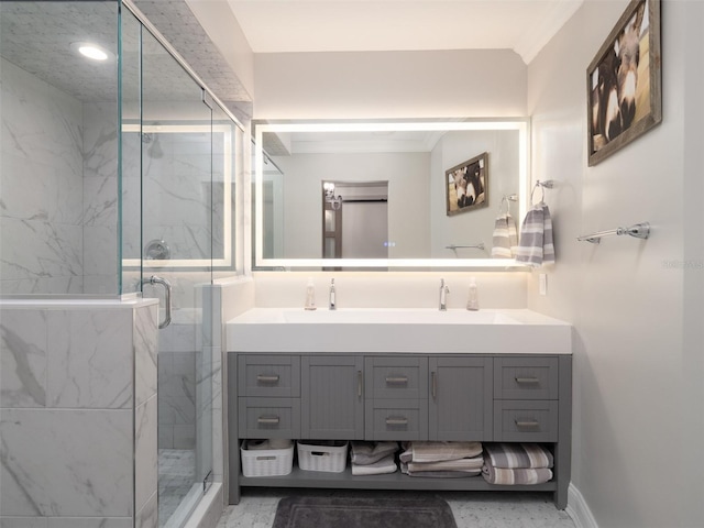 bathroom with dual vanity and an enclosed shower