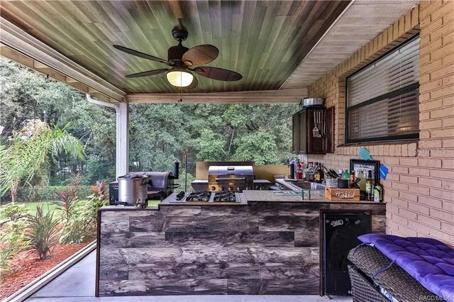 view of patio / terrace featuring area for grilling, outdoor lounge area, ceiling fan, sink, and exterior kitchen