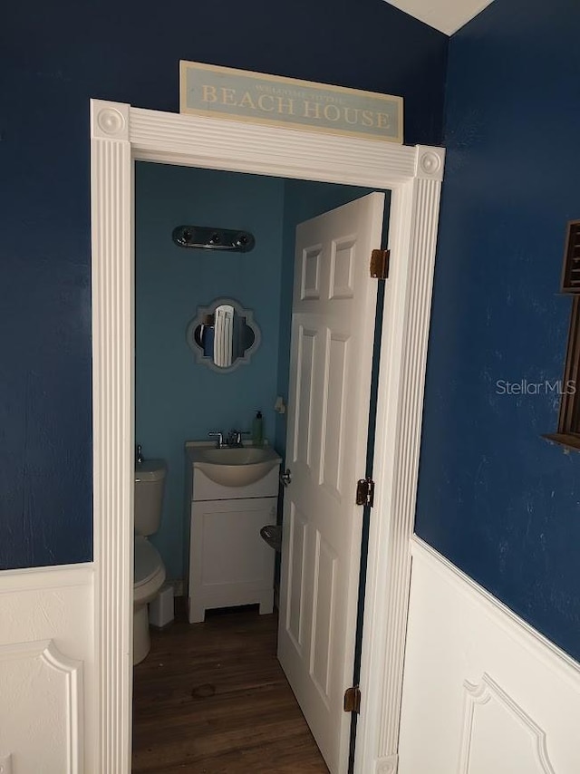 bathroom featuring hardwood / wood-style floors, vanity, and toilet