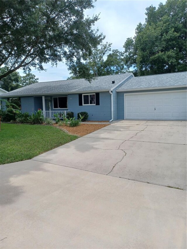 single story home with a front yard and a garage