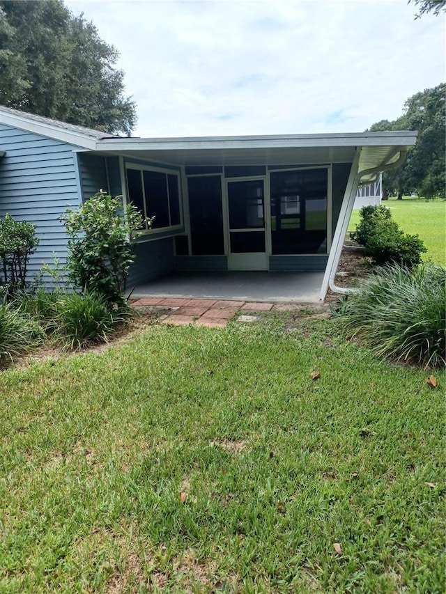 rear view of property with a patio area and a lawn