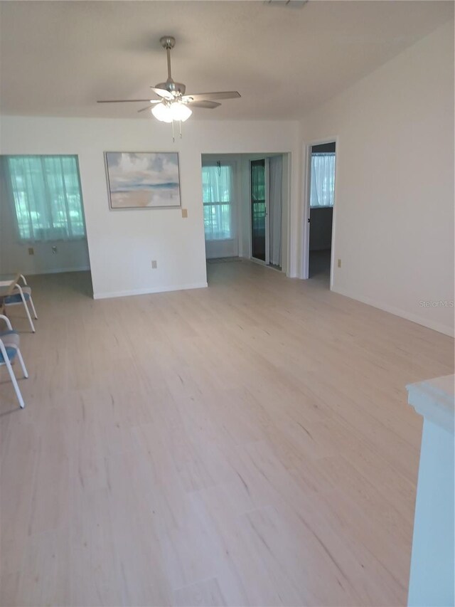 unfurnished living room featuring ceiling fan and light hardwood / wood-style floors