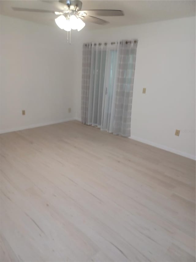 unfurnished room with ceiling fan and light wood-type flooring