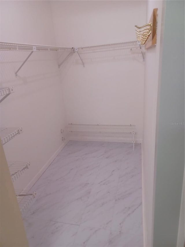 walk in closet with tile patterned floors