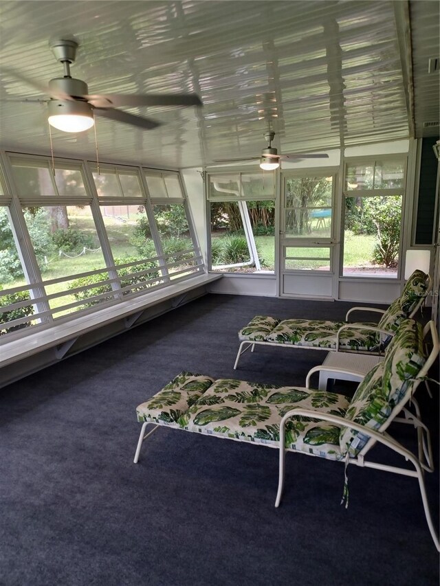 unfurnished sunroom with ceiling fan and a wealth of natural light