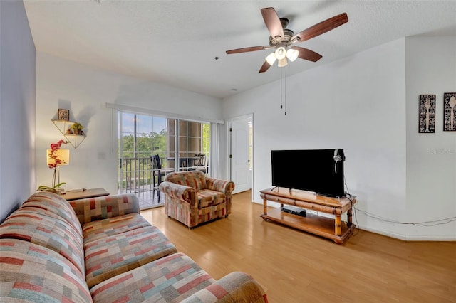 living room featuring light hardwood / wood-style flooring and ceiling fan