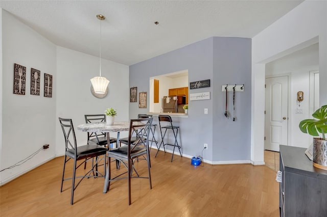 dining space with light hardwood / wood-style flooring