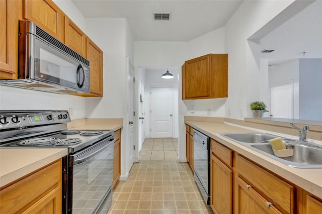 kitchen featuring black appliances, light tile patterned flooring, and sink