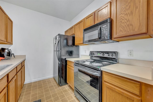 kitchen with black appliances and light tile patterned floors