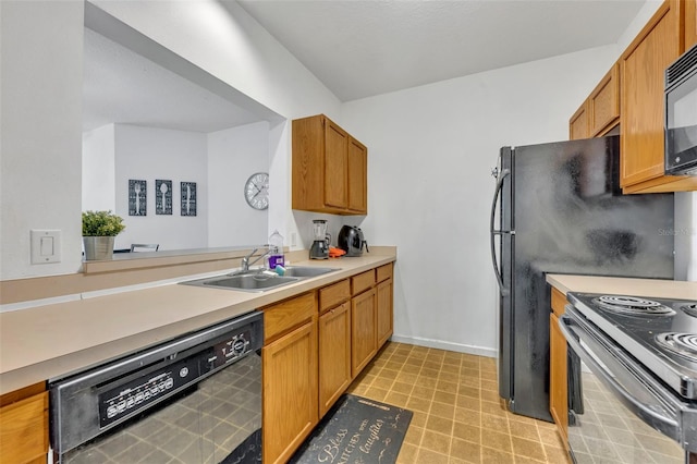 kitchen featuring black appliances, sink, and light tile patterned floors