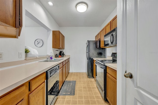 kitchen with light tile patterned flooring, a textured ceiling, sink, and black appliances