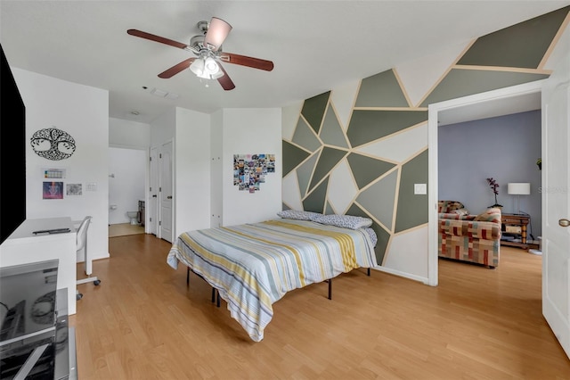 bedroom with ceiling fan and light hardwood / wood-style floors