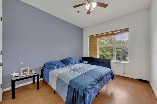 bedroom with ceiling fan and light wood-type flooring