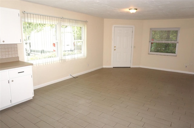 unfurnished room with tile patterned flooring and plenty of natural light