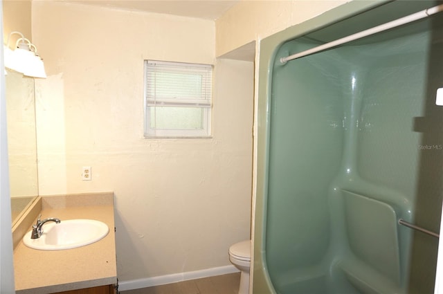 bathroom with a shower with shower door, vanity, and toilet