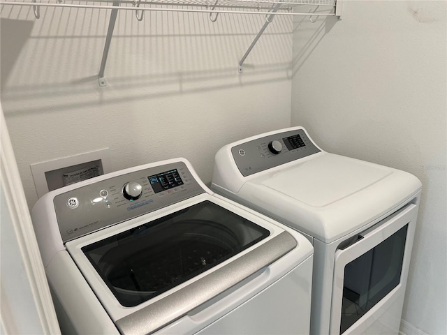 laundry area with separate washer and dryer