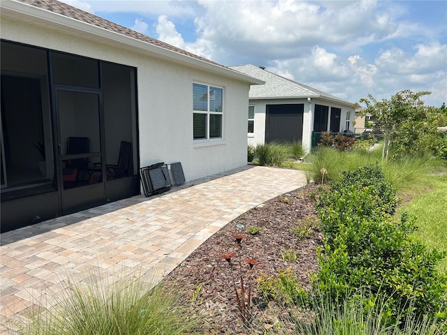 exterior space with a patio area and a sunroom