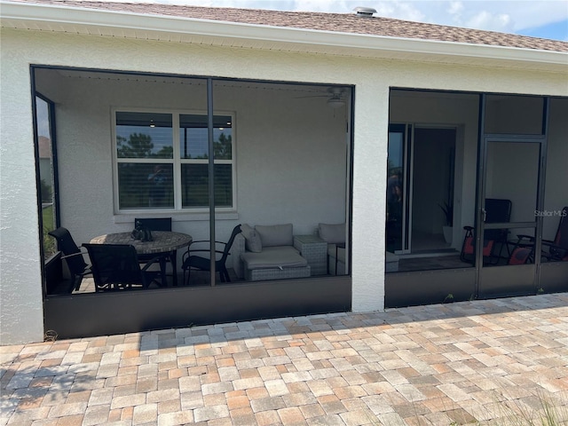 view of patio featuring a sunroom