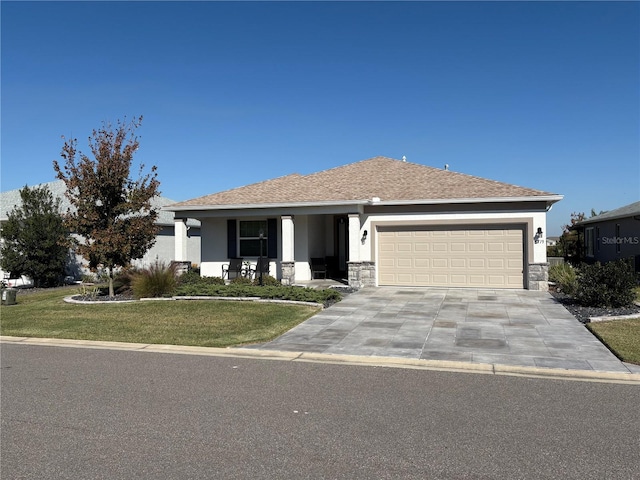 view of front of home featuring a front yard and a garage