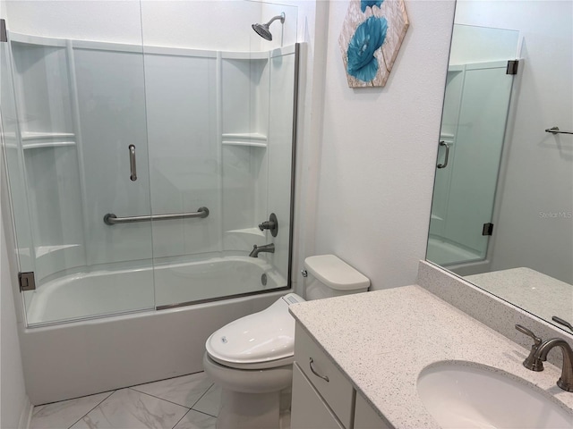 full bathroom featuring vanity, toilet, and bath / shower combo with glass door