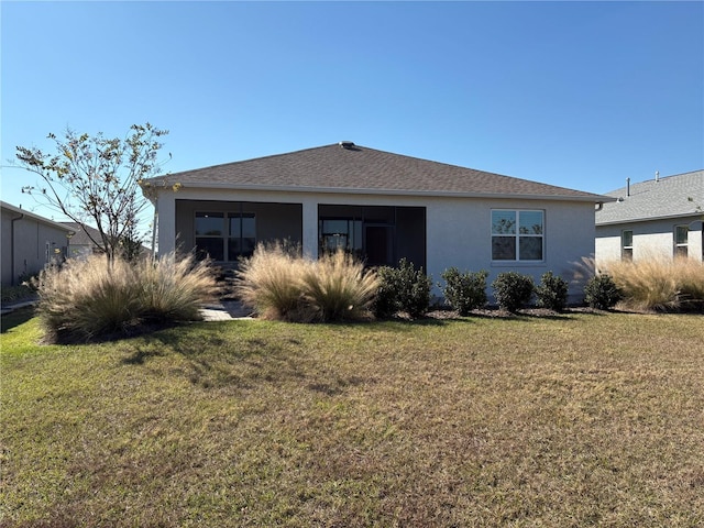 back of house featuring a lawn