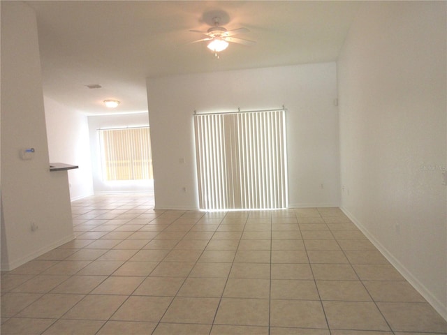 empty room featuring light tile patterned floors and ceiling fan