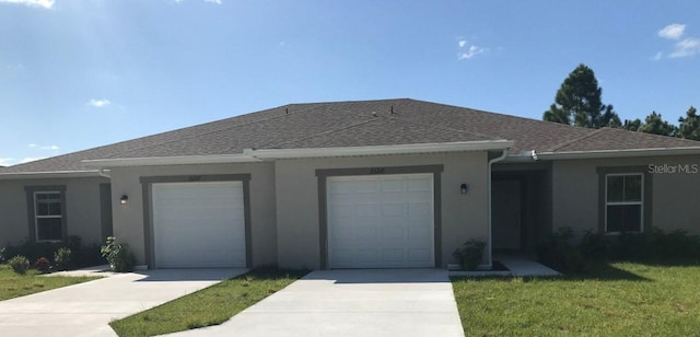 ranch-style house featuring a front yard and a garage