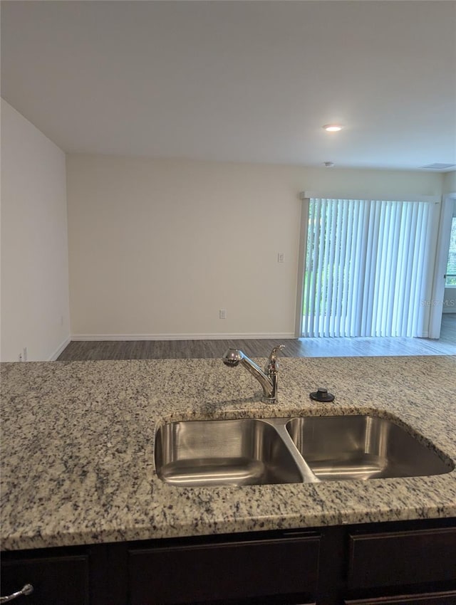 kitchen with light stone countertops and a healthy amount of sunlight