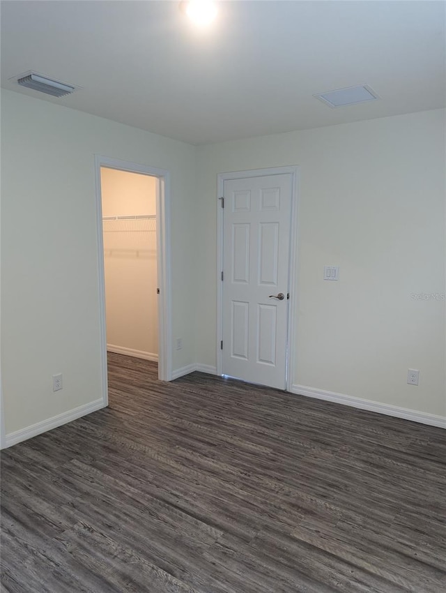 unfurnished room featuring dark wood-type flooring