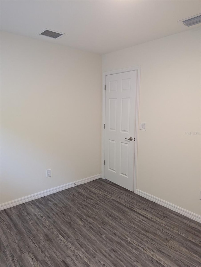 empty room featuring dark hardwood / wood-style flooring