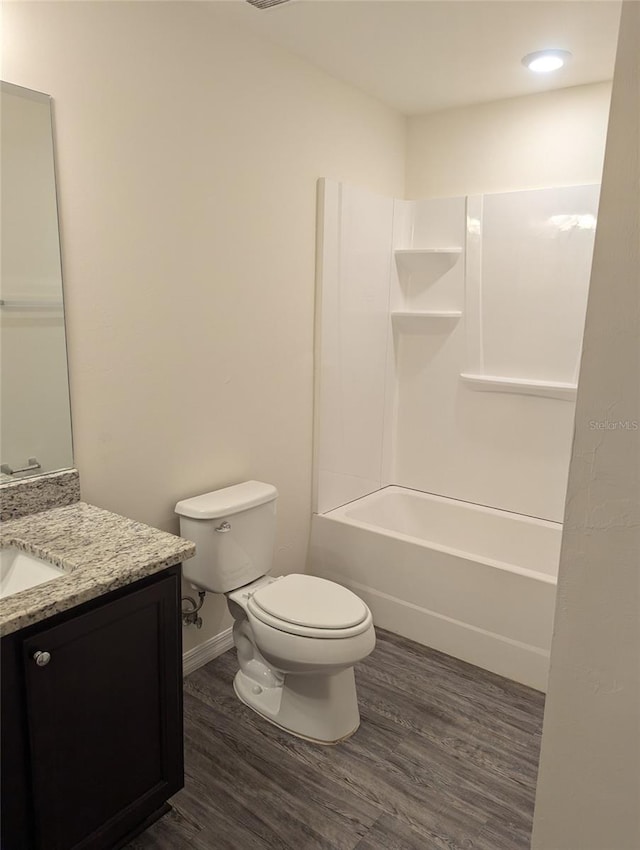 full bathroom with toilet, vanity, bathing tub / shower combination, and wood-type flooring