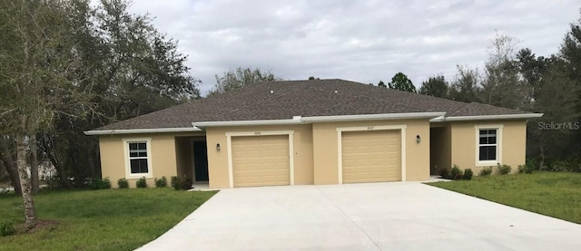 single story home featuring a garage and a front lawn